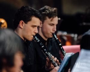 Young Clarinetists performing in an orchestra
