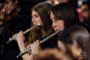 Young Flautists performing in an orchestra