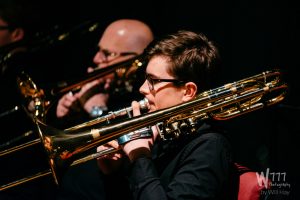 Young Trombonists performing in an orchestra